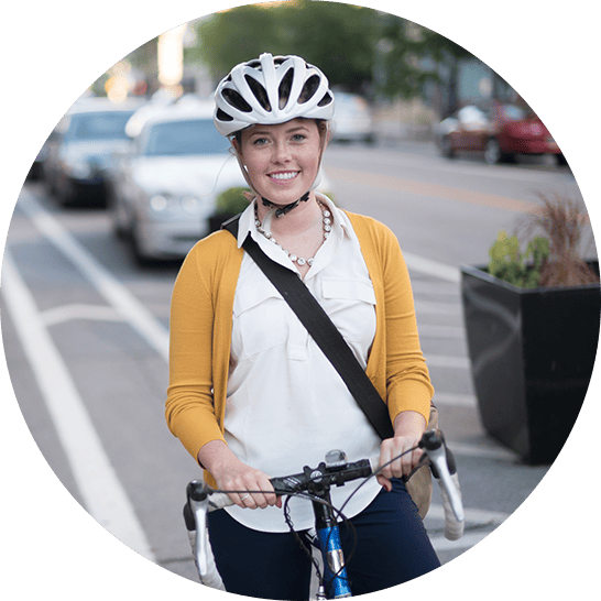 Woman biking on the street with a helmet